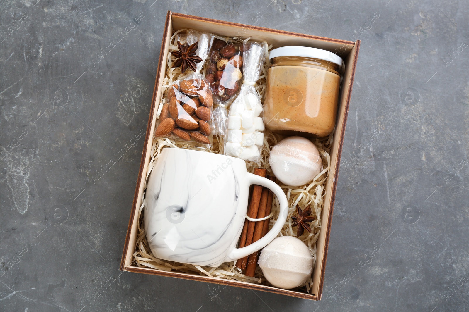 Photo of Box with stylish craft gift set on grey table, top view