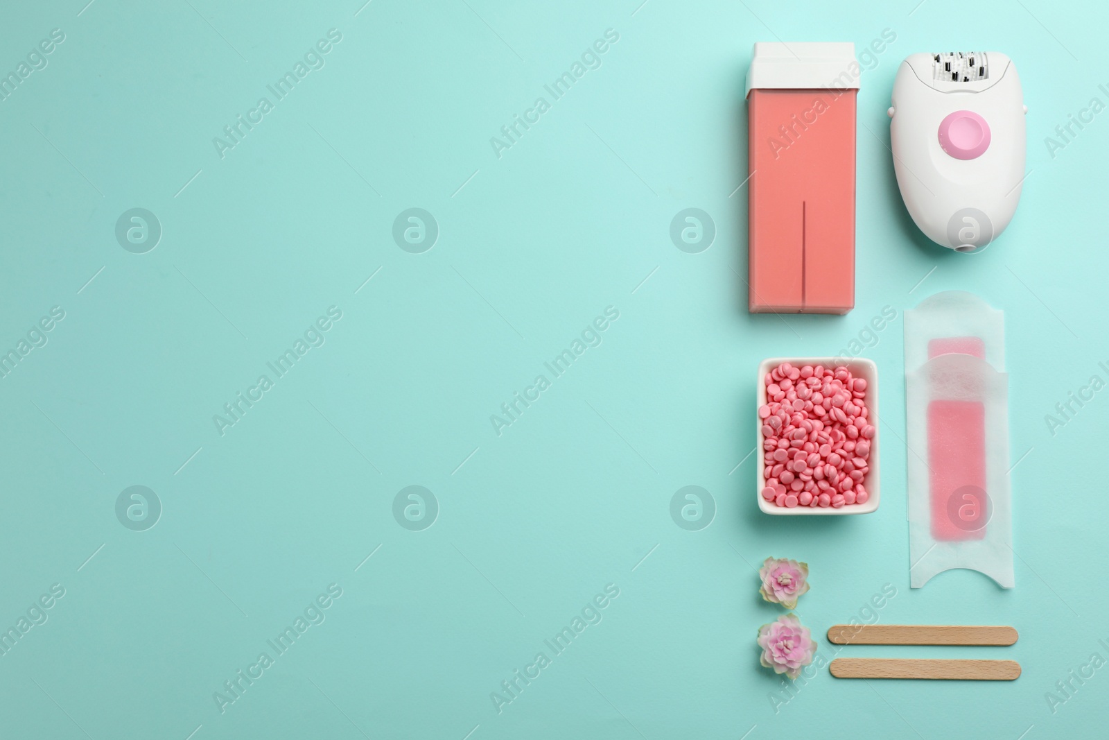 Photo of Set of epilation products on turquoise background, flat lay. Space for text