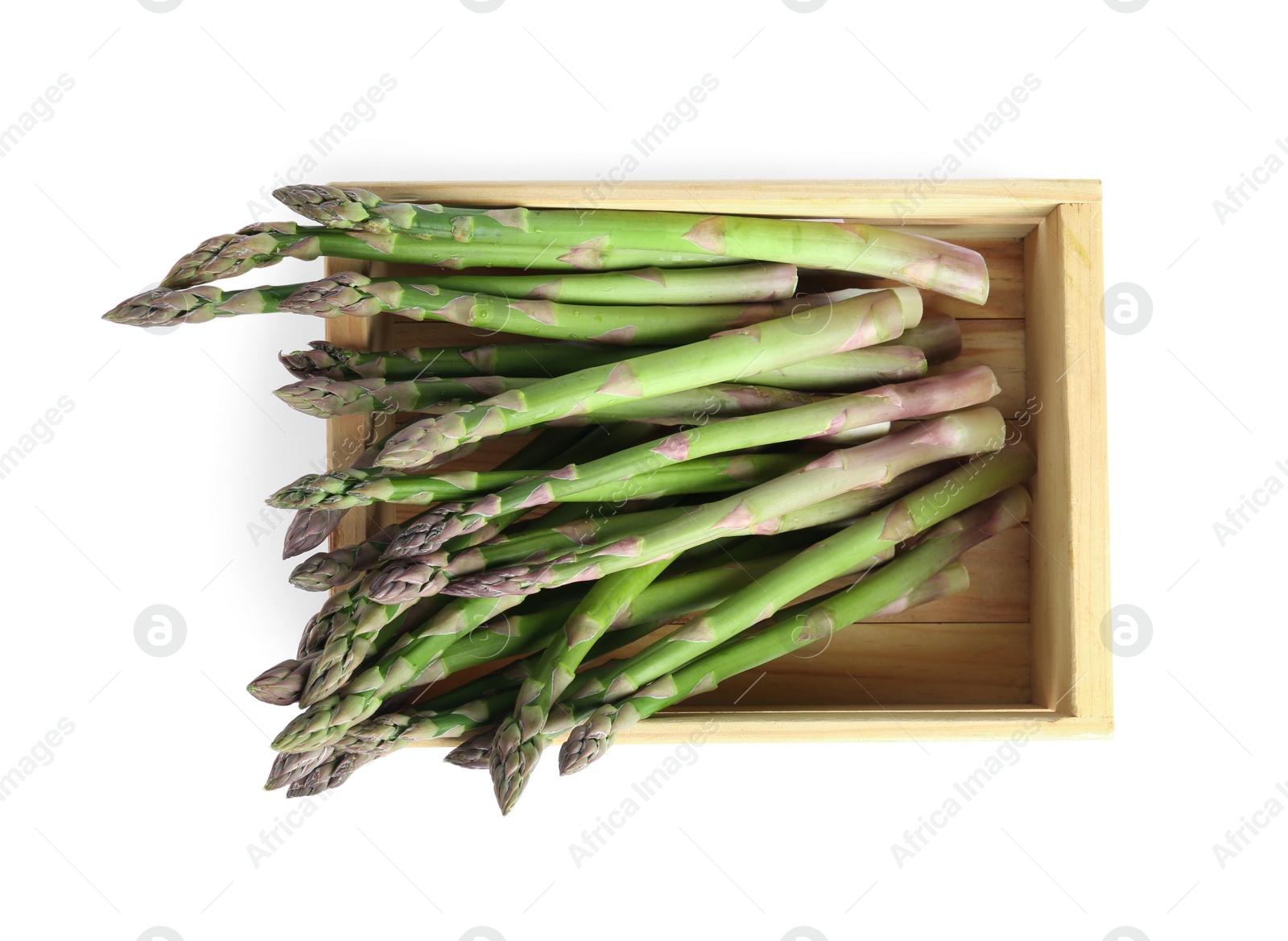 Photo of Fresh raw asparagus in wooden crate isolated on white, top view