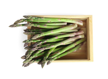 Photo of Fresh raw asparagus in wooden crate isolated on white, top view