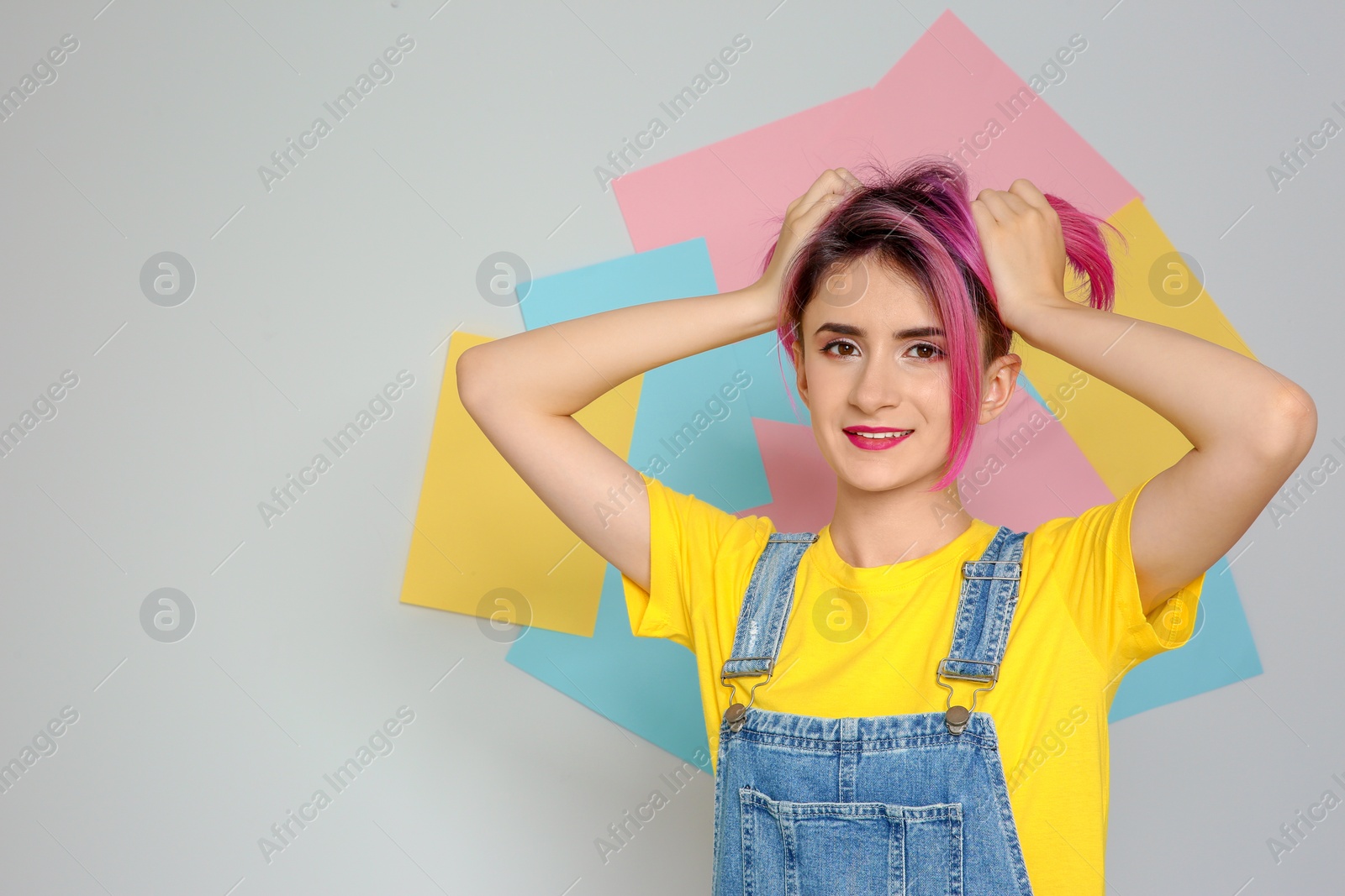 Photo of Young woman with trendy hairstyle against color background