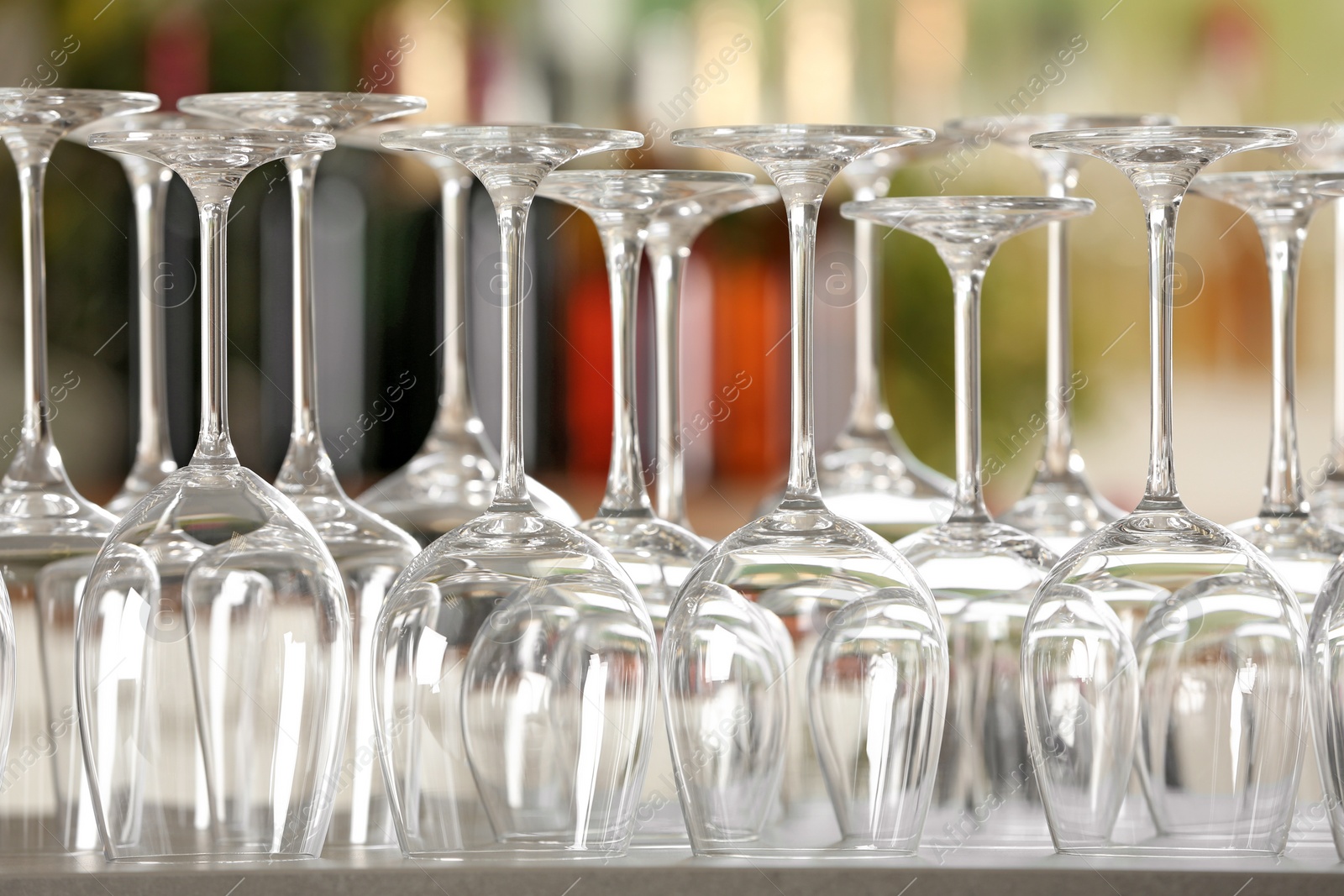 Photo of Empty glasses on table against blurred background