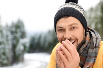 Photo of Man in warm clothes outdoors, space for text. Winter vacation