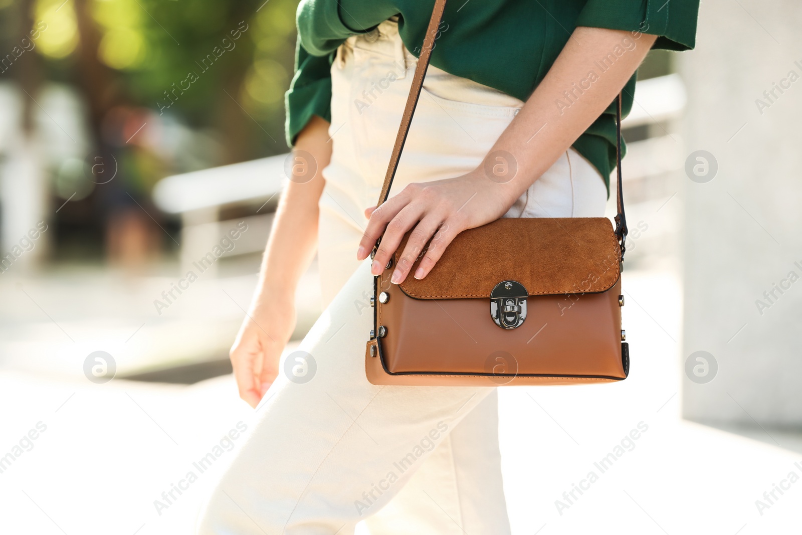 Photo of Young woman with stylish leather bag outdoors on summer day, closeup