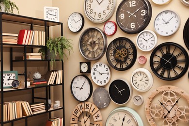 Stylish room interior with collection of wall clocks