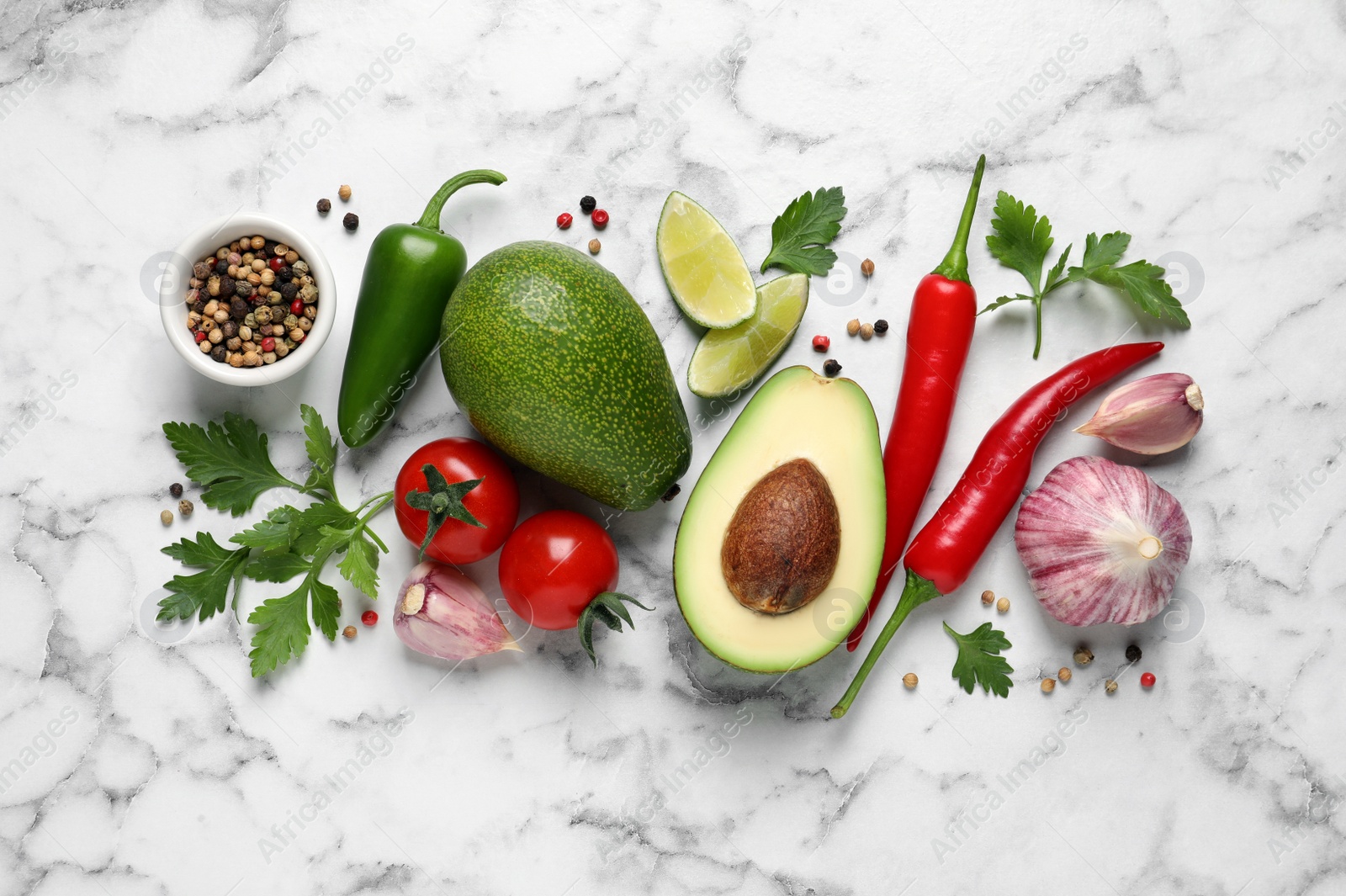 Photo of Fresh ingredients for guacamole on white marble table, flat lay