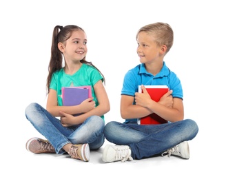 Little children with school supplies on white background