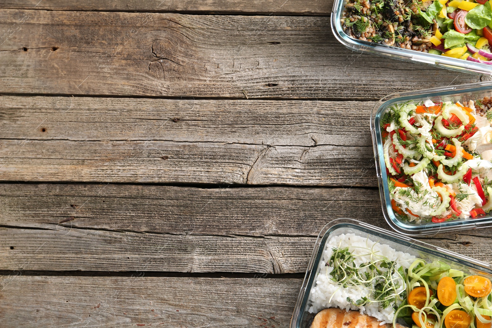 Photo of Healthy meal. Containers with different products on wooden table, flat lay. Space for text