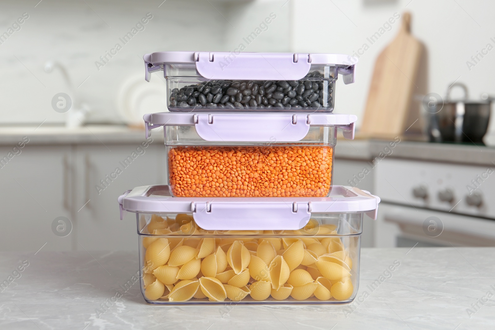 Photo of Stacked boxes with different food on table in kitchen