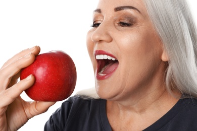 Smiling woman with perfect teeth and red apple on white background, closeup