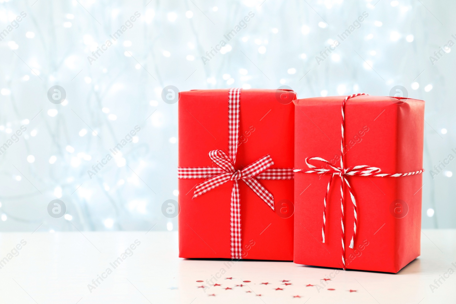 Photo of Christmas gifts on table against blurred background