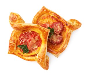 Fresh delicious puff pastry with cheese, tomatoes and parsley on white background, top view