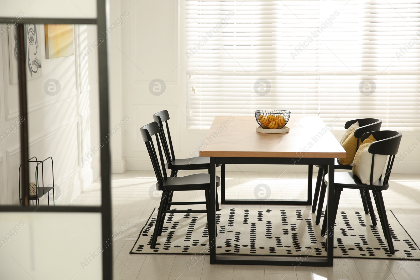 Photo of Stylish wooden dining table and chairs in room. Interior design