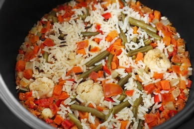 Photo of Prepared rice with vegetables in multi cooker, closeup