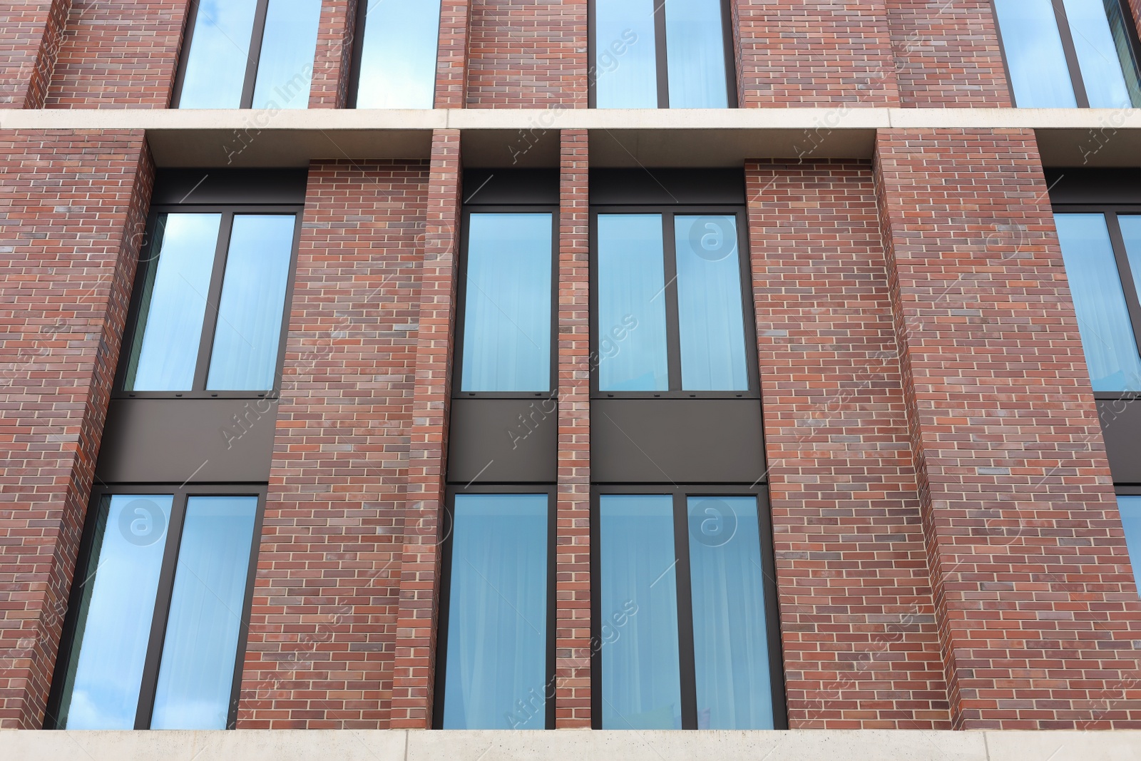 Photo of Modern red brick building with beautiful windows