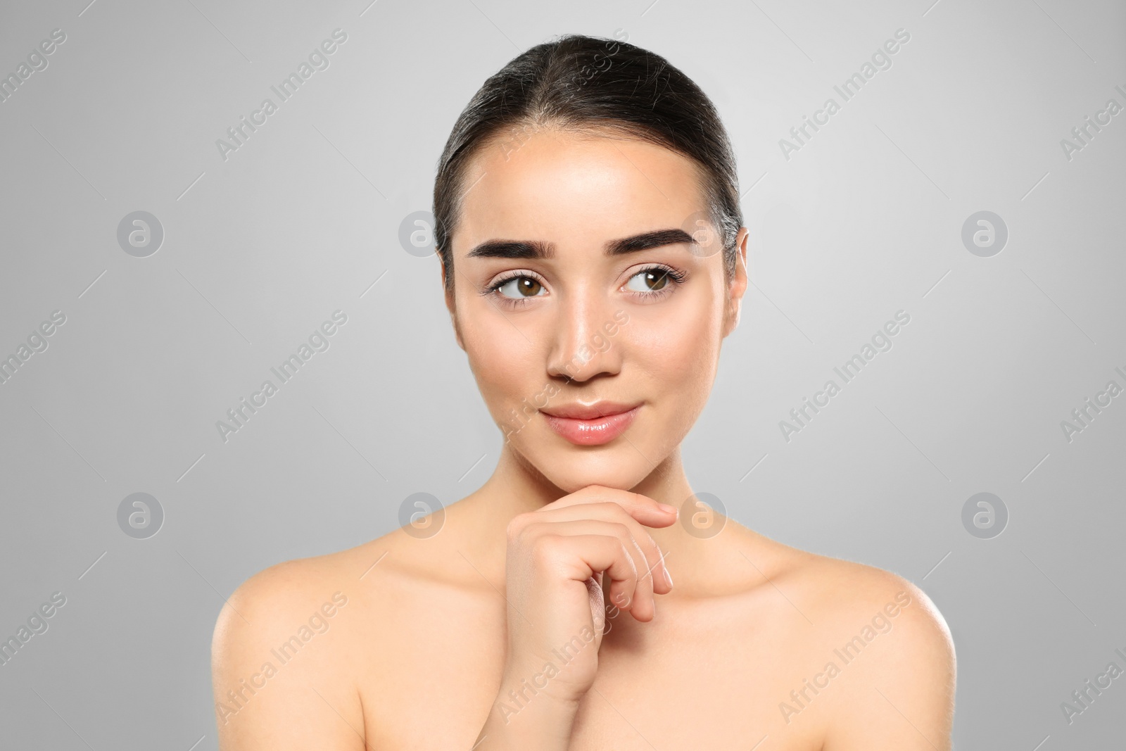 Photo of Portrait of young woman with beautiful face against color background