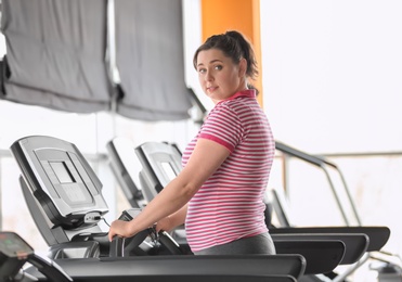 Overweight woman training in gym