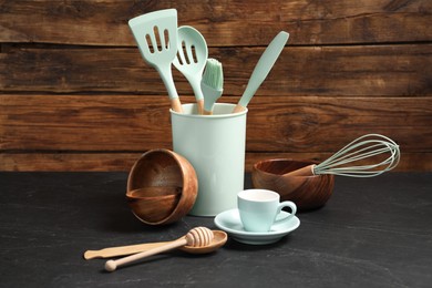 Photo of Set of different kitchen utensils on grey table