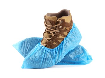 Photo of Boots in blue shoe covers isolated on white