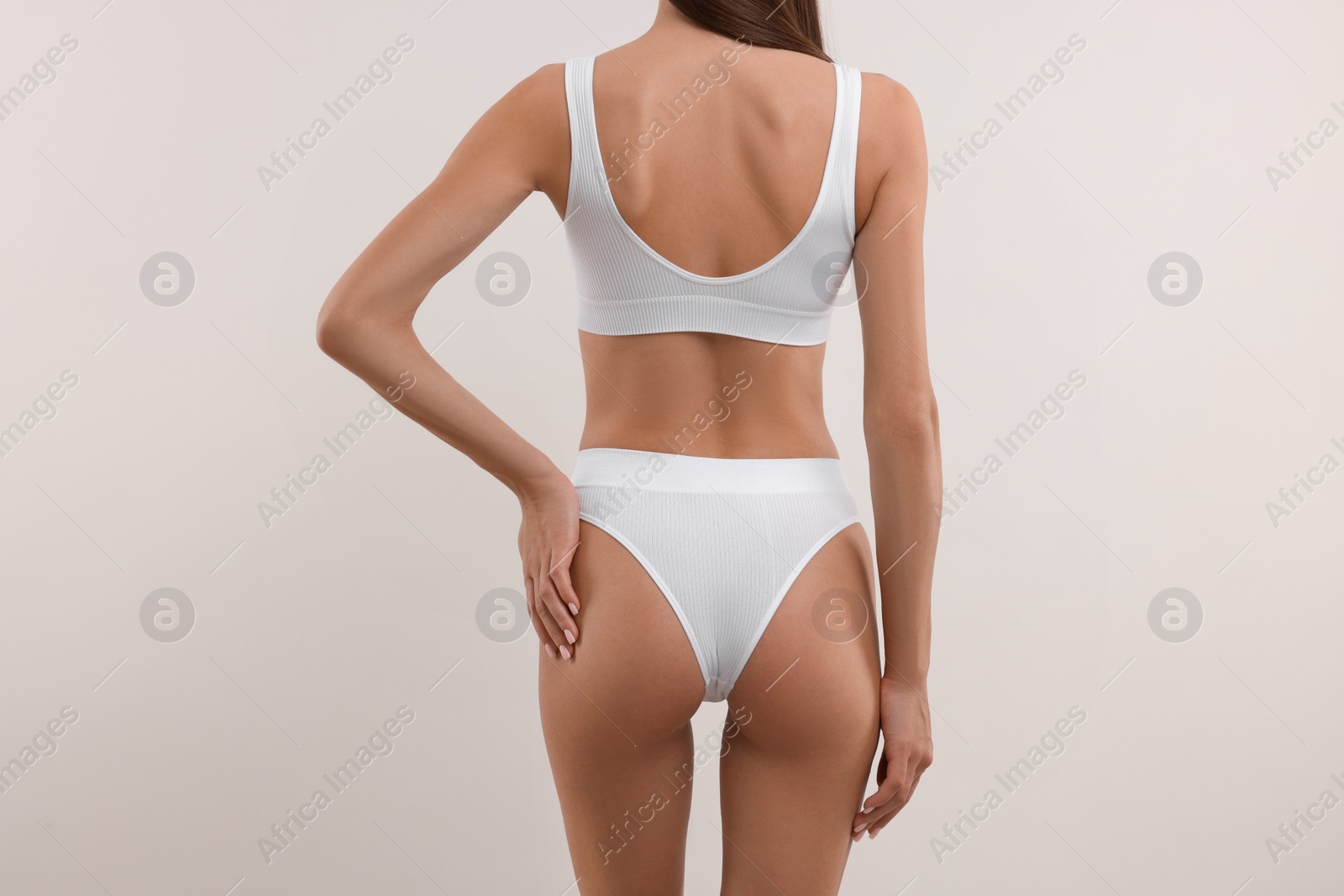 Photo of Young woman in stylish bikini on white background, closeup