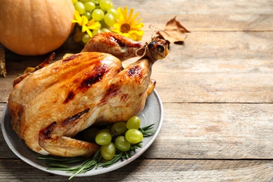 Delicious turkey on wooden background, space for text. Happy Thanksgiving day