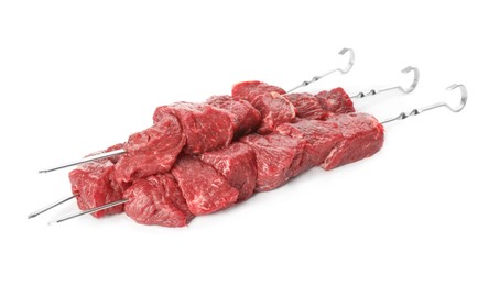 Photo of Metal skewers with raw meat on white background