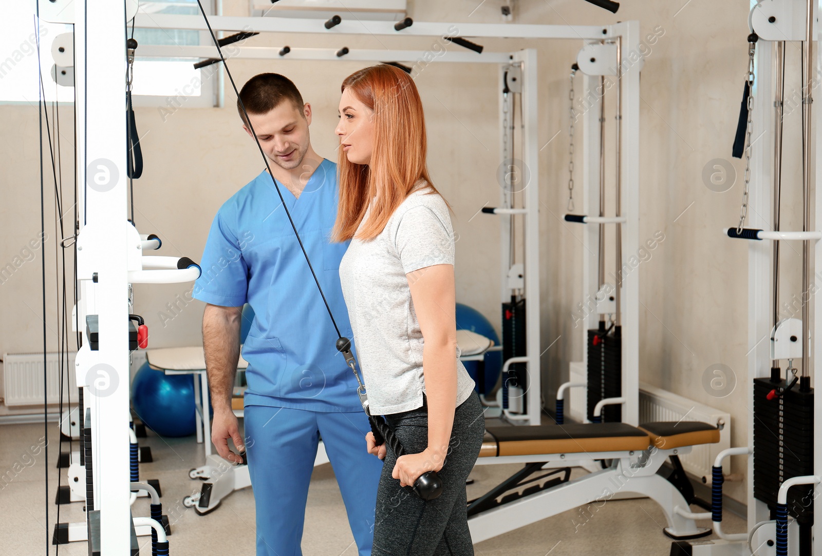 Photo of Patient exercising under physiotherapist supervision in rehabilitation center