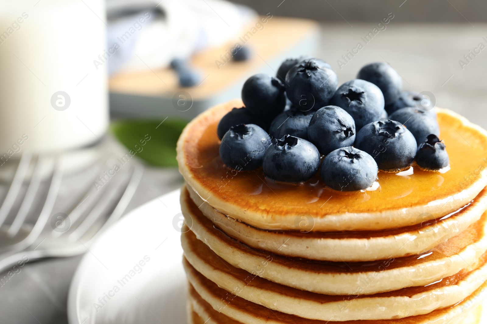 Photo of Plate with pancakes and berries on table, closeup