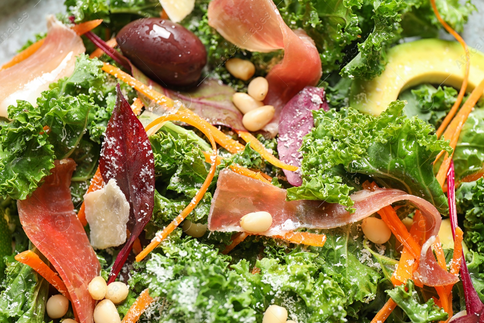 Photo of Tasty fresh kale salad as background, closeup