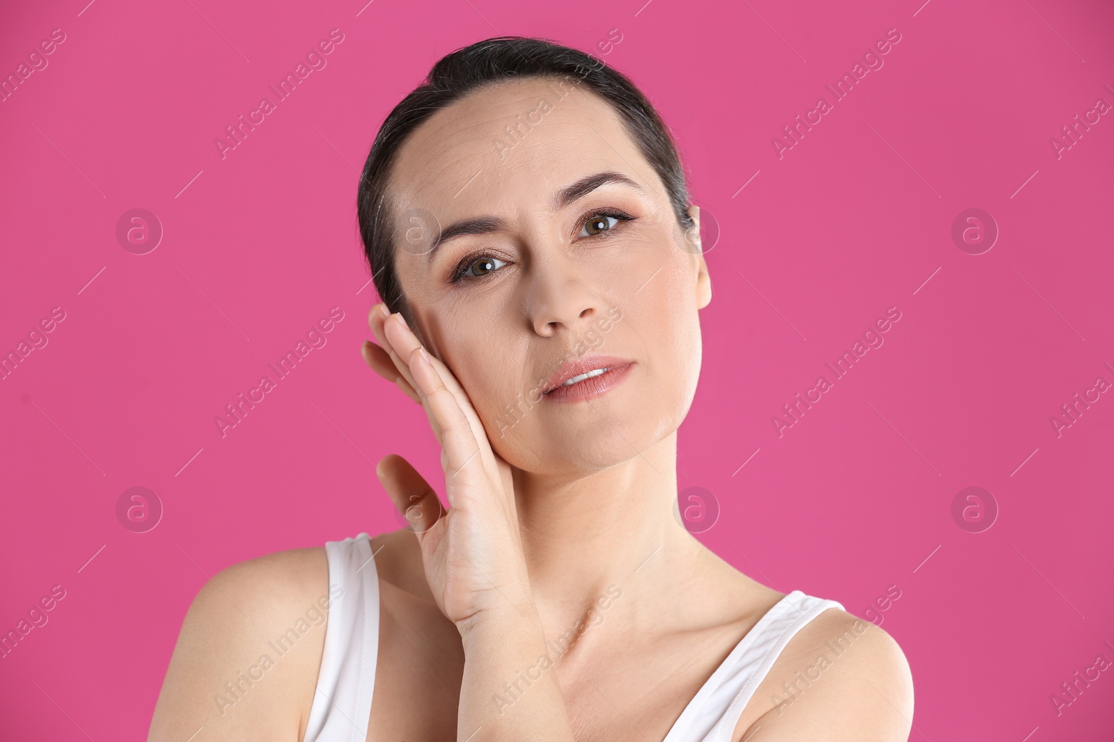 Photo of Portrait of beautiful mature woman on pink background