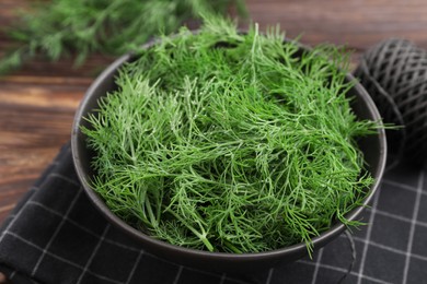 Photo of Bowl of fresh dill on table, closeup