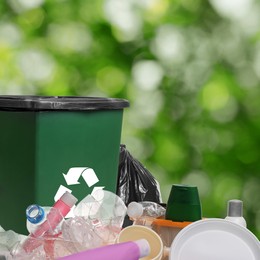 Image of Waste bin surrounded by garbage on blurred background, space for text