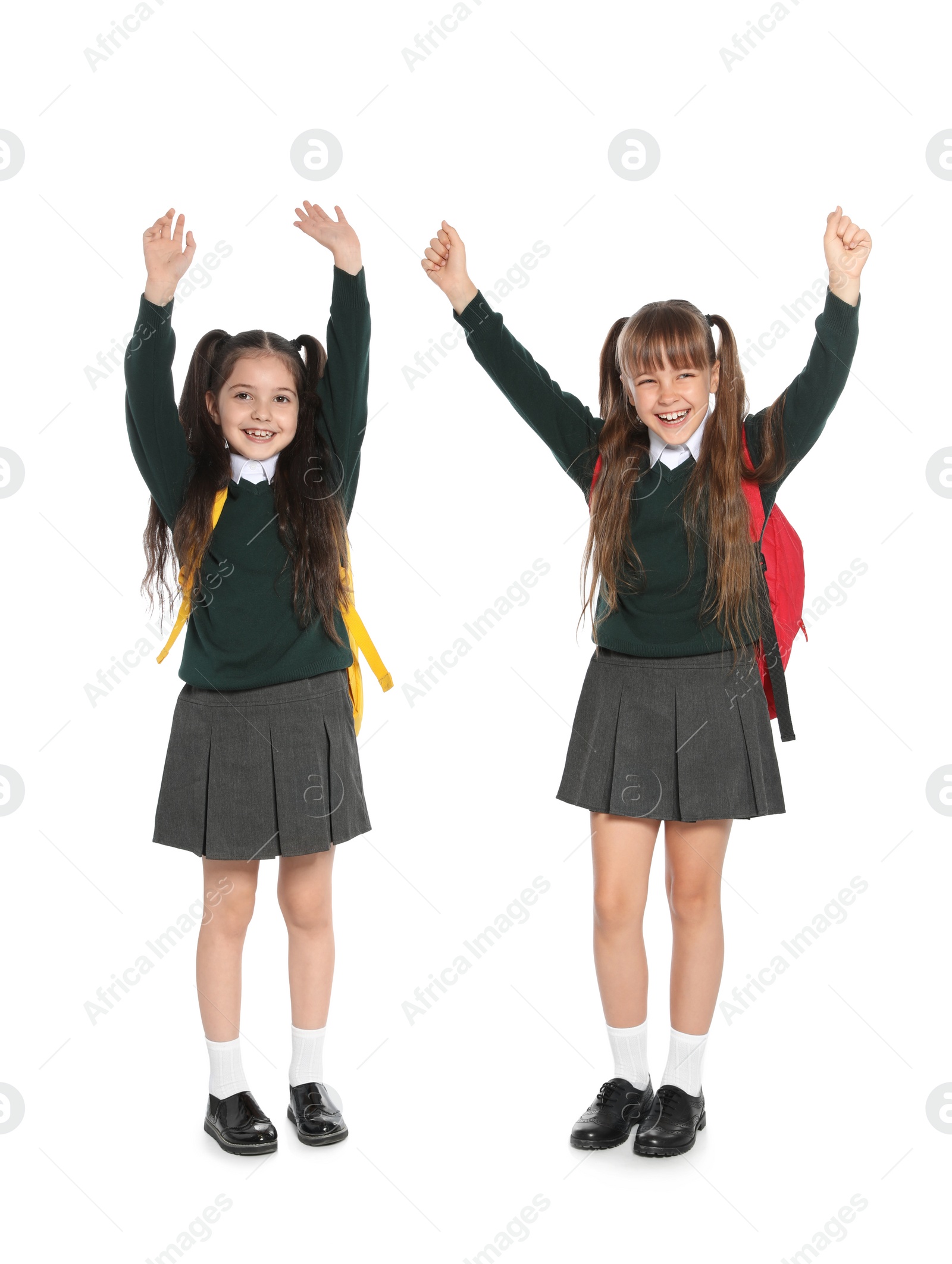 Photo of Little girls in stylish school uniform on white background