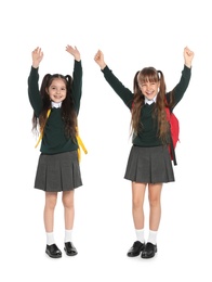 Little girls in stylish school uniform on white background