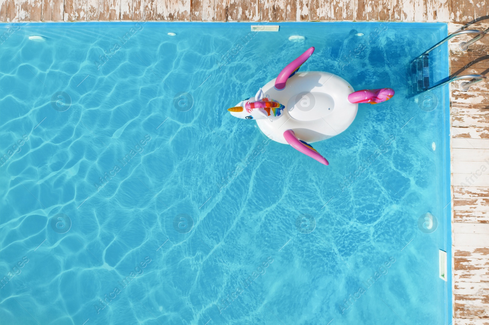 Image of Swimming pool with inflatable ring, top view. Space for text