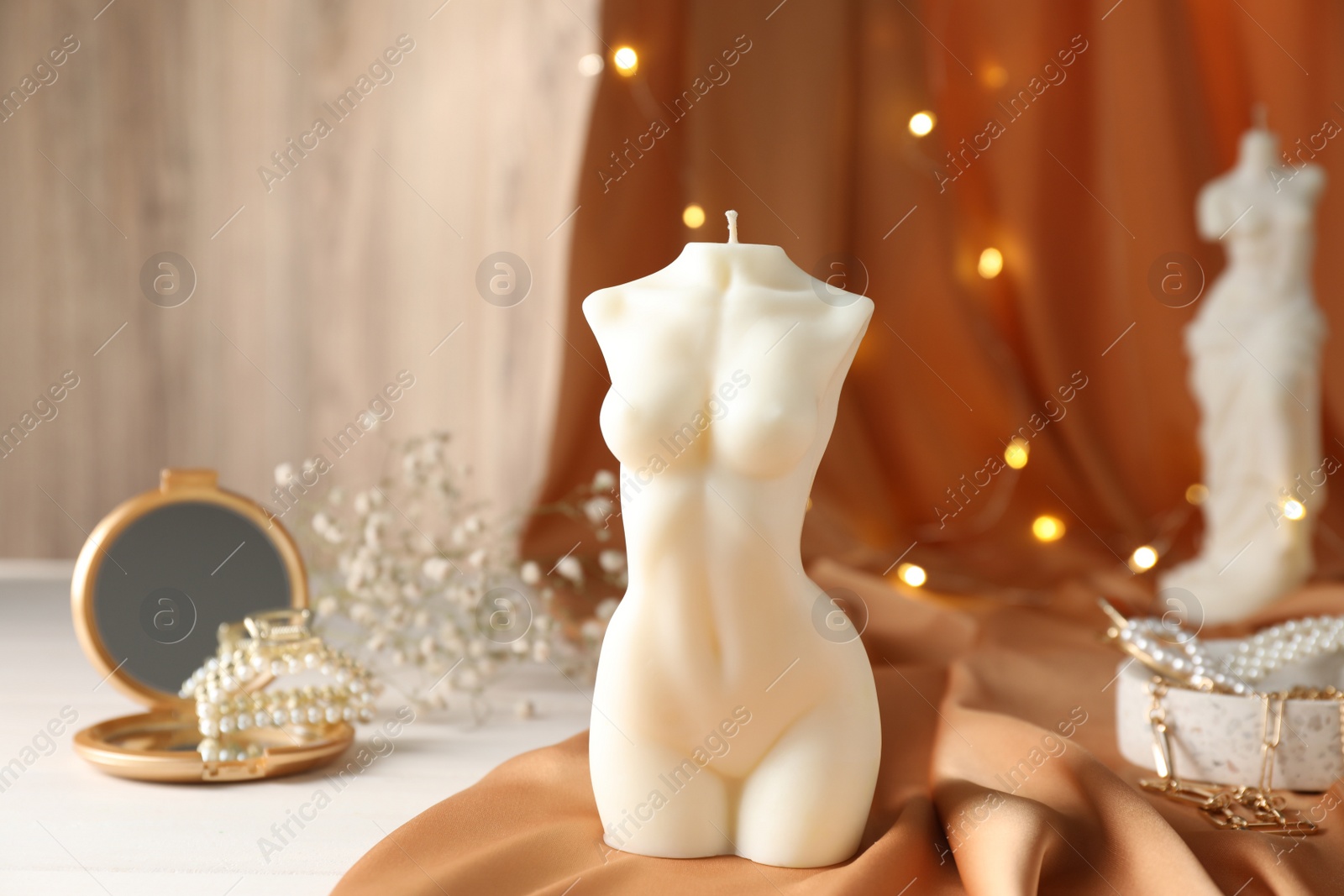 Photo of Composition with beautiful female body shaped candle on white table