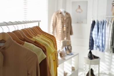 Photo of Collection of stylish women's clothes in modern boutique