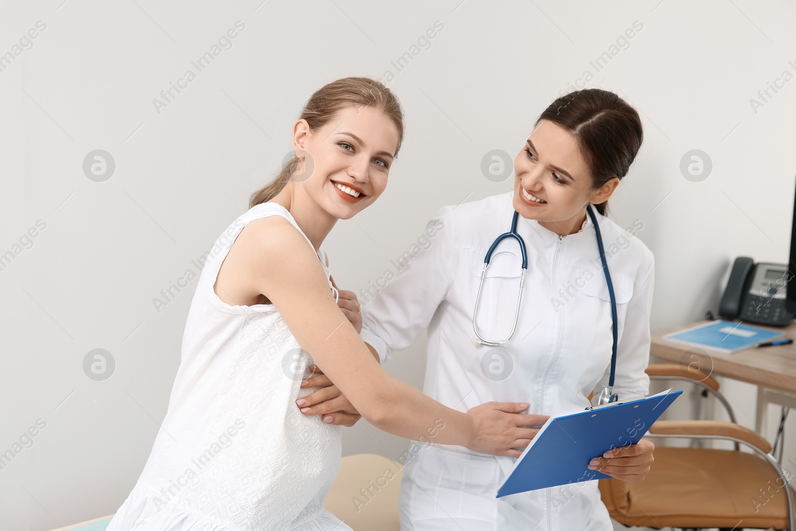 Photo of Pregnant woman having appointment at gynecologist office