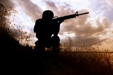Soldier with machine gun patrolling outdoors. Military service