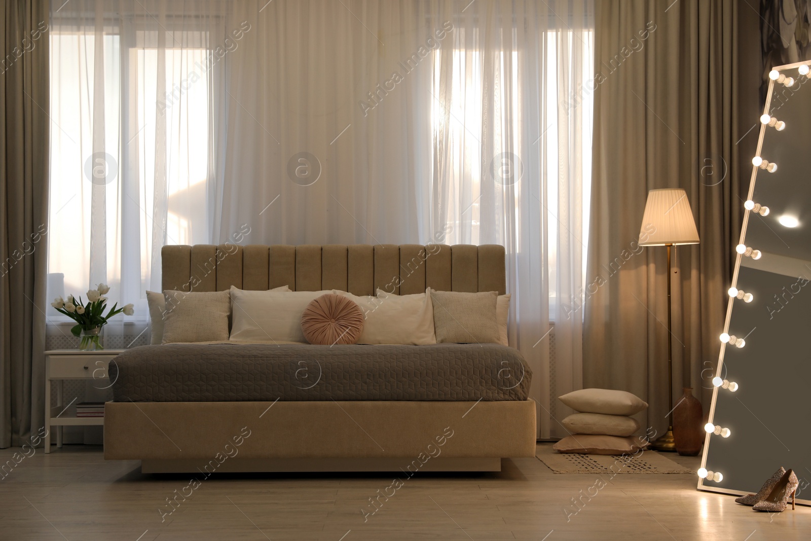Photo of Beautiful room interior with large bed and mirror