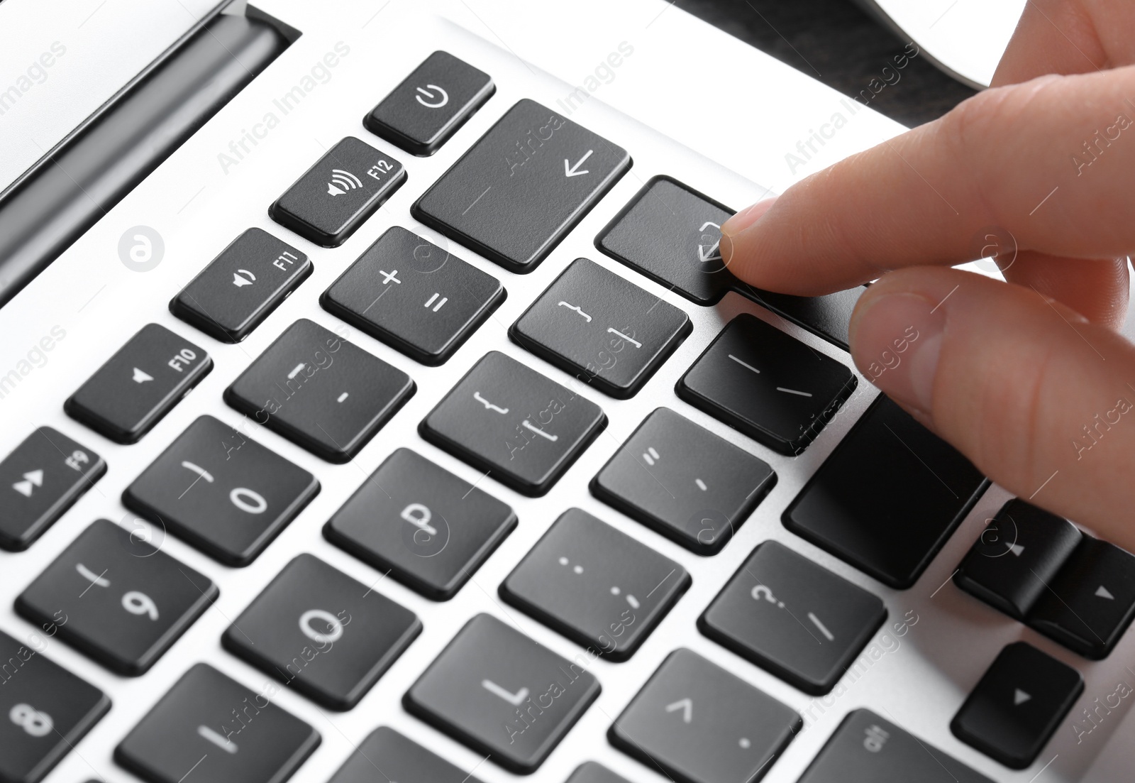 Photo of Woman pressing button on laptop keyboard, closeup