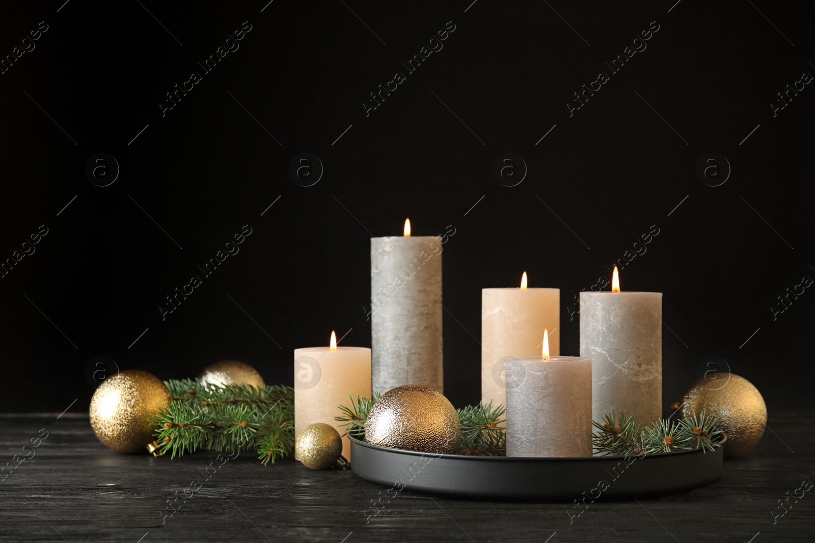 Photo of Burning candles with Christmas decoration on table. Space for text