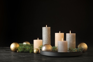 Photo of Burning candles with Christmas decoration on table. Space for text