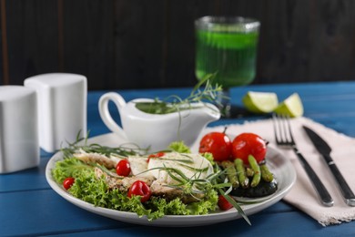 Photo of Tasty mozzarella, chicken and vegetables with tarragon served on blue wooden table