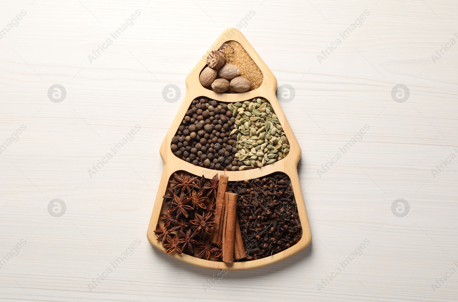 Photo of Different spices and nuts on white wooden table, top view