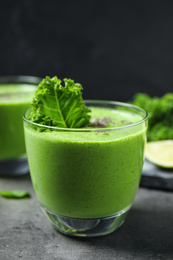 Photo of Tasty kale smoothie with chia seeds on grey table