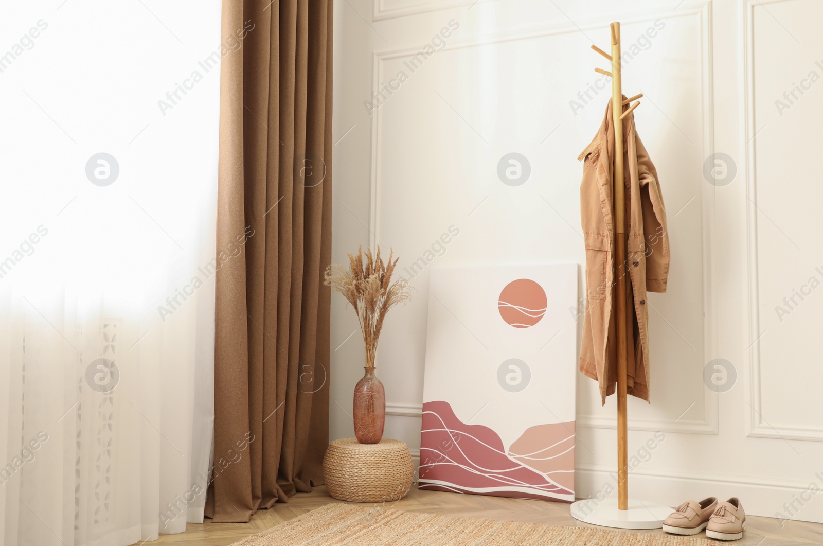 Photo of Fluffy reed plumes and painting in hallway interior