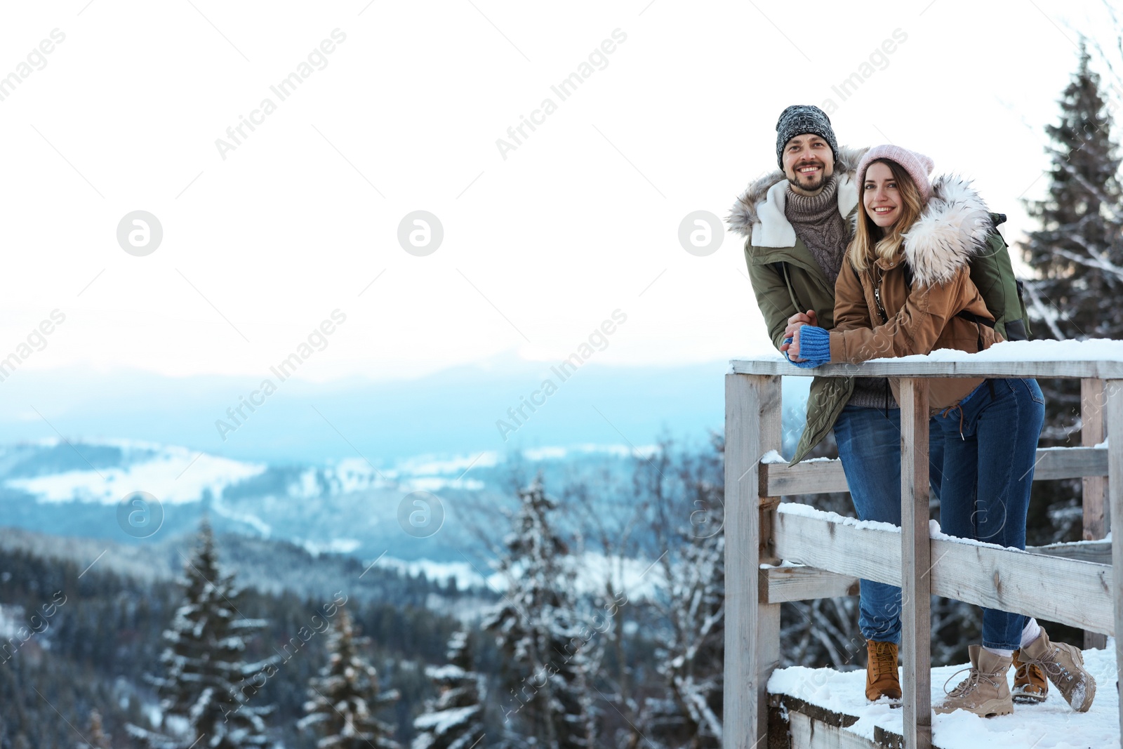 Photo of Couple spending winter vacation together in mountains. Space for text