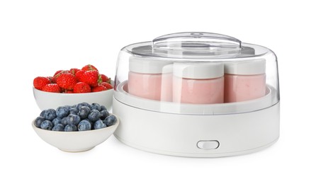 Photo of Modern yogurt maker with full jars and berries on white background