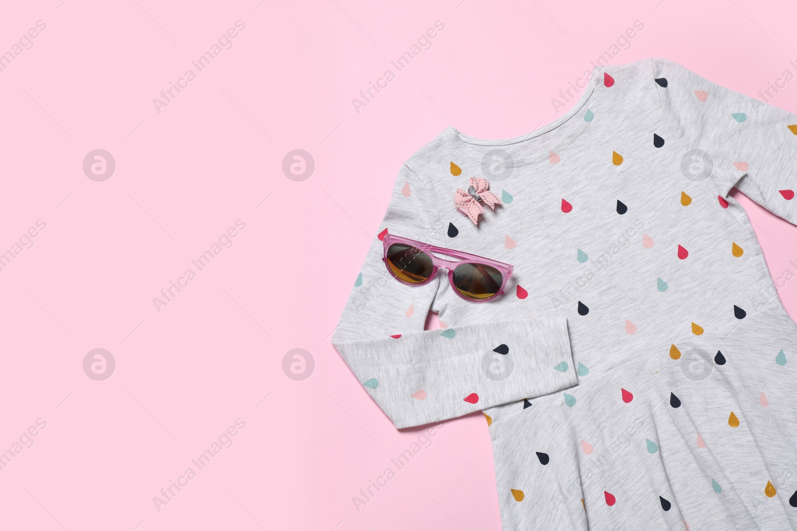 Photo of Beautiful dress and accessories on pink background, flat lay. Space for text